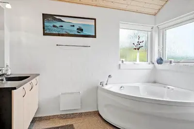 a white bathroom with a large tub and a sink at 512-Thisted-Sotungevej-4 in Thisted