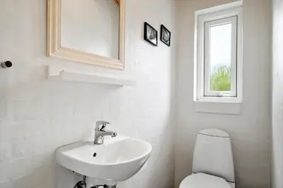 a bathroom with a sink and a toilet and a window at 512-Thisted-Sotungevej-4 in Thisted