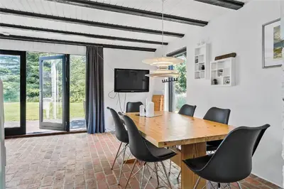 a dining room with a wooden table and chairs at 142-Thisted-Pighvarvej-4 in Thisted