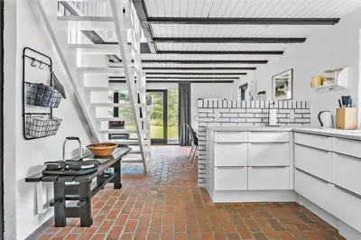 a kitchen with white cabinets and a table at 142-Thisted-Pighvarvej-4 in Thisted