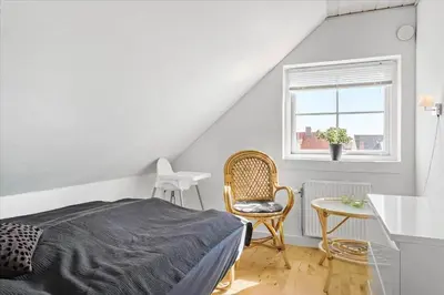 a bedroom with a bed and a table and a window at 133-Thisted-Jorgen-Hedes-Vej-10 in Thisted