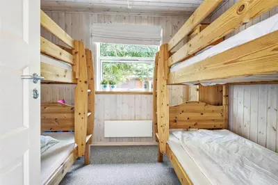 two bunk beds in a room with a window at 879-Thisted-Pighvarvej-3 in Thisted