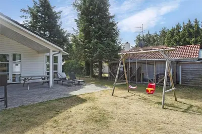a yard with a swing set in front of a house at 879-Thisted-Pighvarvej-3 in Thisted