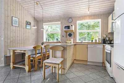 a kitchen with a table and chairs in a room at 879-Thisted-Pighvarvej-3 in Thisted