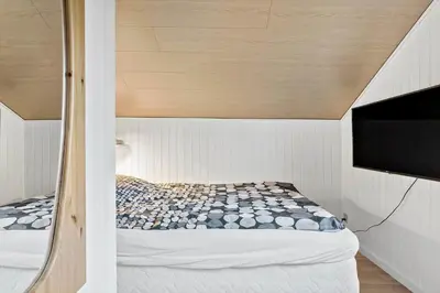 a bed in a small room with a tv at 145-Thisted-Fiskervej-25-B in Thisted