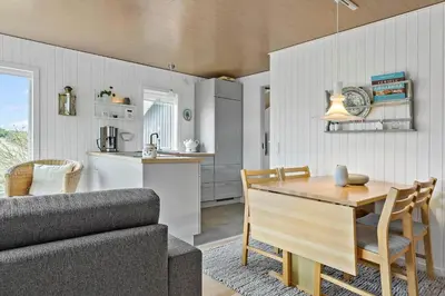 a kitchen and living room with a table and a couch at 145-Thisted-Fiskervej-25-B in Thisted
