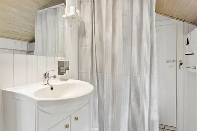 a bathroom with a sink and a shower curtain at 145-Thisted-Fiskervej-25-B in Thisted