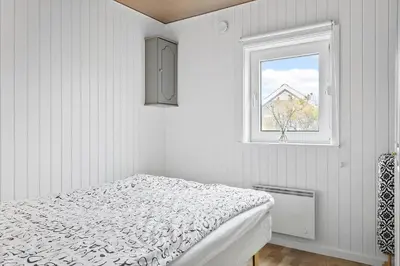 a white bedroom with a bed and a window at 145-Thisted-Fiskervej-25-B in Thisted