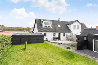 a white house with a black roof and a yard at 822-Thisted-Bredkaervej-8 in Thisted