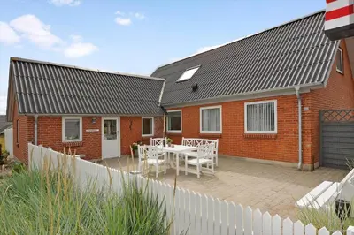 a house with a patio with a table and chairs at 172-Thisted-Fiskervej-72 in Thisted