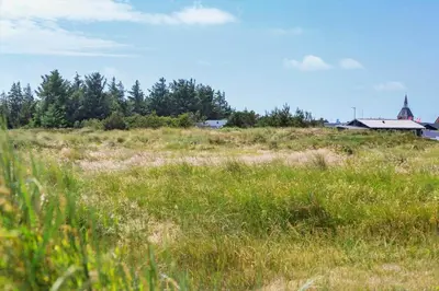 a field of grass with a house in the background at 172-Thisted-Fiskervej-72 in Thisted