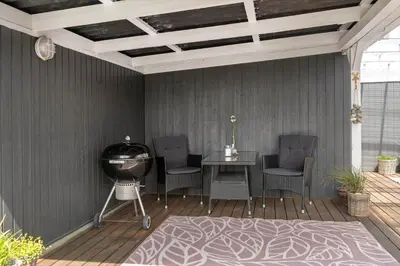 a patio with a grill and chairs and a table at 576-Thisted-Klemsvej-26-E in Thisted