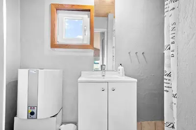 a bathroom with a sink and a white refrigerator at 276-Thisted-Nordsovej-76 in Thisted