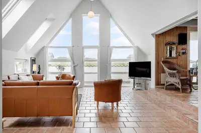 a living room with a couch and a tv at 186-Vestervig-Magevej-5 in Vestervig