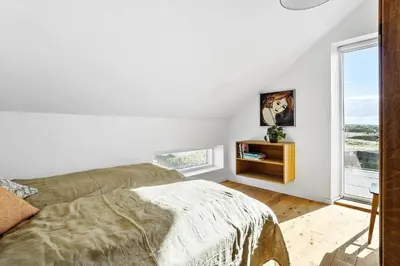a white bedroom with a bed and a window at 1053-Thisted-Kraenhavs-Sti-8 in Torsted