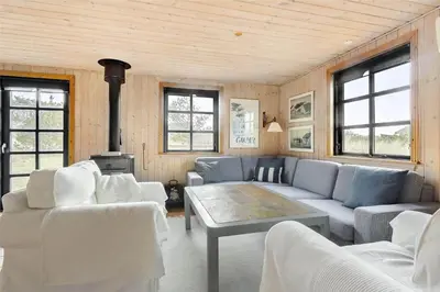 a living room with a couch and a table at 520-Snedsted-Sarasvej-10 in Snedsted