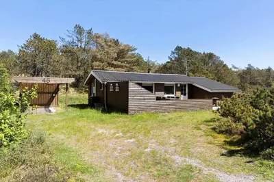 a cabin in a field next to a forest at 815-Thisted-Blamunkevej-45 in Thisted