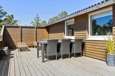 a patio with a table and chairs on a deck at 815-Thisted-Blamunkevej-45 in Thisted