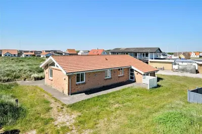 a small brick house on top of a grass field at 451-Thisted-Nordsovej-20 in Thisted
