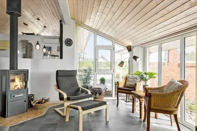 a living room with chairs and a fireplace at 451-Thisted-Nordsovej-20 in Thisted