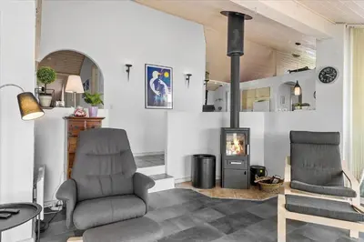 a living room with two chairs and a fireplace at 451-Thisted-Nordsovej-20 in Thisted