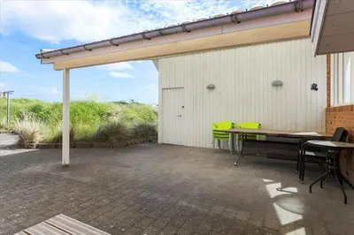 a patio with a table and green chairs at 451-Thisted-Nordsovej-20 in Thisted