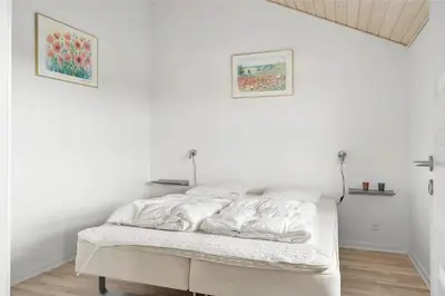 a white bedroom with a bed with white sheets at 409-Thisted-Flyndervej-8 in Thisted