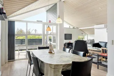 a dining room with a table and some chairs at 409-Thisted-Flyndervej-8 in Thisted
