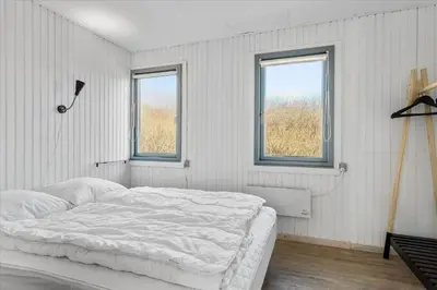 a white bedroom with a bed and two windows at 828-Thisted-Orredvej-13 in Thisted