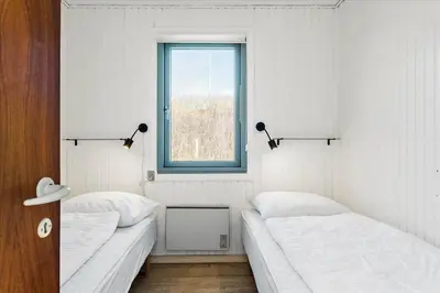 two beds in a white room with a window at 828-Thisted-Orredvej-13 in Thisted