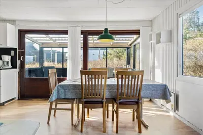 a dining room with a table and chairs and a window at 828-Thisted-Orredvej-13 in Thisted