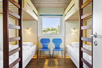two blue chairs in a room with bunk beds at 969-Thisted-Klitstien-50 in Torsted