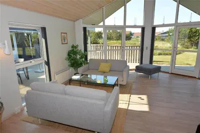 a living room with a couch and a table at 969-Thisted-Klitstien-50 in Torsted