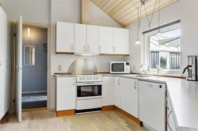 a white kitchen with white appliances and a window at 969-Thisted-Klitstien-50 in Torsted