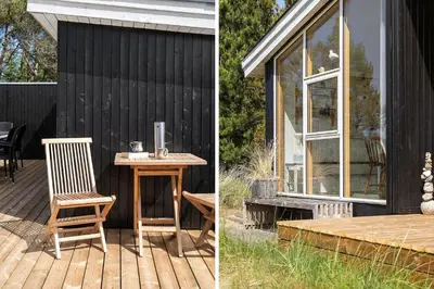 a house with a table and a chair on a deck at 638-Thisted-Lyngvej-6 in Thisted