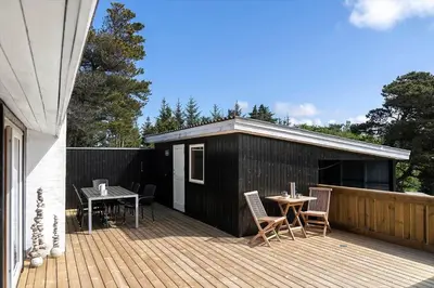 a patio with a table and chairs on a wooden deck at 638-Thisted-Lyngvej-6 in Thisted