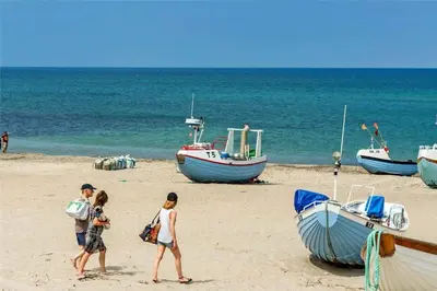 a group of people walking on a beach with boats at 770-Thisted-Nordsovej-180 in Thisted