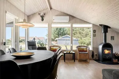 a living room with a table and a wood stove at 770-Thisted-Nordsovej-180 in Thisted