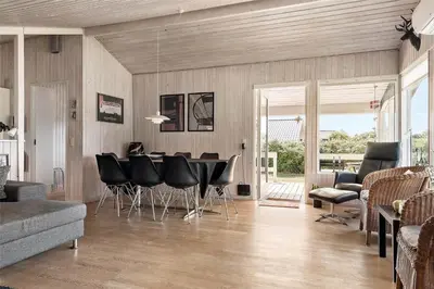 a living room with a table and black chairs at 770-Thisted-Nordsovej-180 in Thisted
