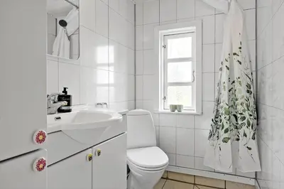 a white bathroom with a toilet and a sink at 1308-Thisted-Tunvej-12 in Thisted