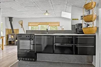 a kitchen with a black stove and a sink at 1308-Thisted-Tunvej-12 in Thisted