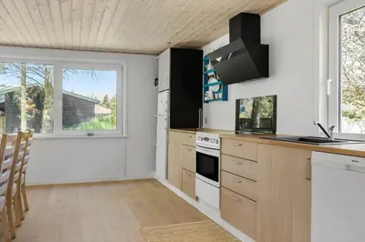a kitchen with a stove top oven next to a window at 535-Thisted-Molgaardsvej-75 in Thisted