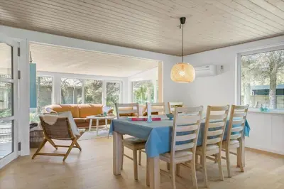 a dining room with a blue table and chairs at 535-Thisted-Molgaardsvej-75 in Thisted