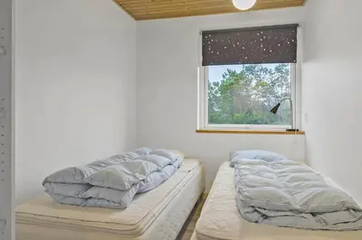 two beds in a room with a window at 991-Thisted-Liusborg-Sti-23 in Torsted