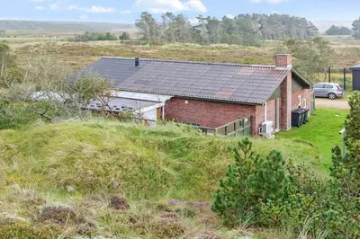 a brick house with a solar roof on a field at 991-Thisted-Liusborg-Sti-23 in Torsted