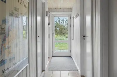 a hallway with a door and a window at 1052-Thisted-Bavnbak-50 in Torsted
