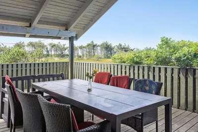 a wooden deck with a table and chairs at 1052-Thisted-Bavnbak-50 in Torsted