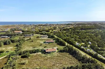 an aerial view of a field with trees and houses at 1052-Thisted-Bavnbak-50 in Torsted