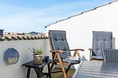 two chairs sitting on a patio with a table at 417-Vestervig-Havnevej-1-lejl-17 in Vestervig