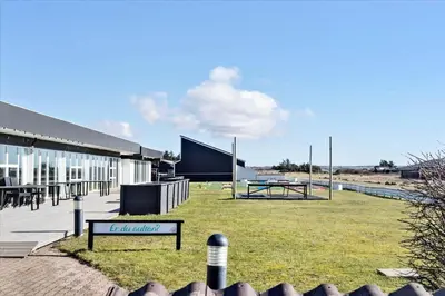 a building with a park with a picnic table at 417-Vestervig-Havnevej-1-lejl-17 in Vestervig
